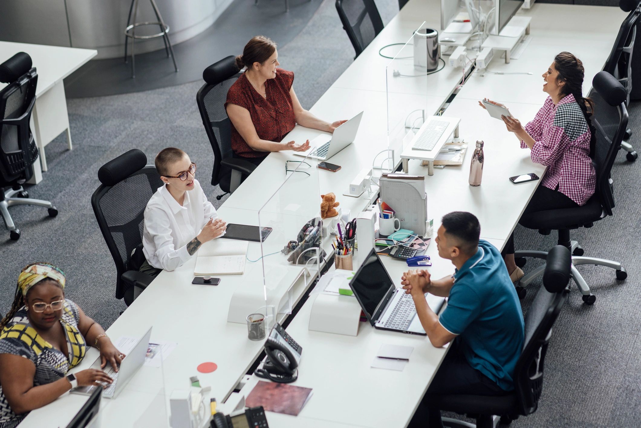 Editorial team collaborating in a modern newsroom office