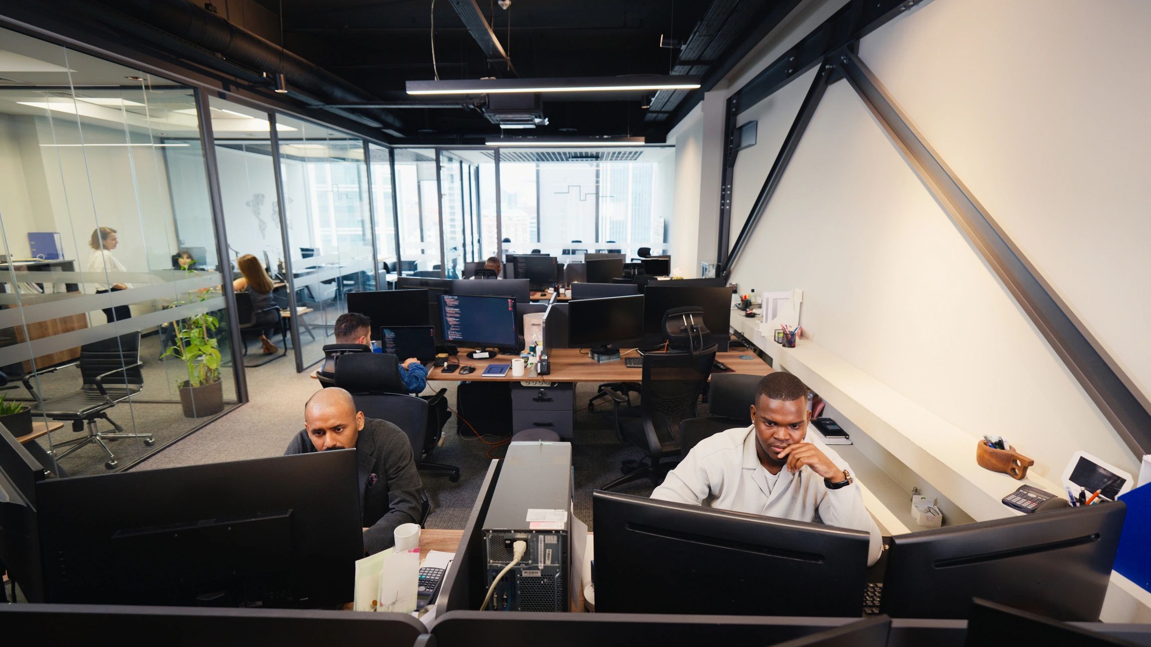 Business team collaborating in a modern newsroom-style office